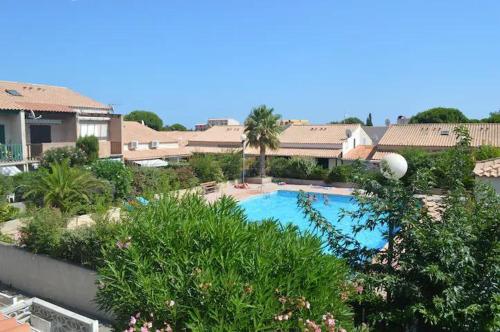une vue aérienne d'une piscine dans un complexe hôtelier dans l'établissement L'Appart de Karine et Nico, à Gruissan