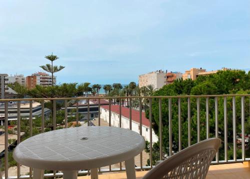 a table and chairs on a balcony with a view of a city at Apartamentos Hesperia Palmyra in Salou