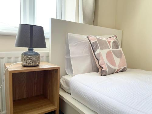 1 dormitorio con 1 cama con lámpara en una mesita de noche en Karuna House, en Norwich