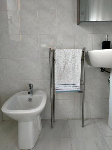 a bathroom with a sink and a toilet and a bidet at Apartment in Sardinia in Decimomannu