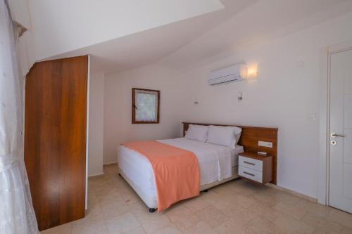 Ένα ή περισσότερα κρεβάτια σε δωμάτιο στο Infinity Olympia Villas