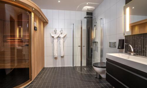 a bathroom with a shower and a toilet and a sink at Thon Partner Hotel Kungsbron in Stockholm