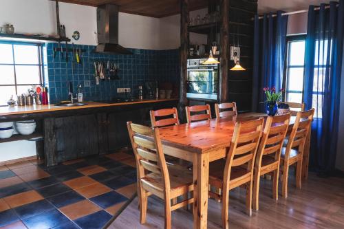 a dining room with a wooden table and chairs at Tiiupesa Guest House in Hellamaa