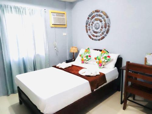 a bedroom with two beds and a window at BACKDOOR VILLA in Baler