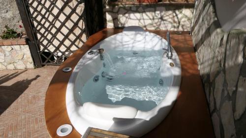 a jacuzzi tub on top of a balcony at Villetta Incanto relax in Cava deʼ Tirreni