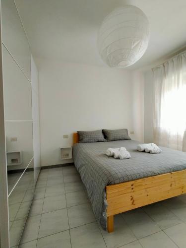 a bedroom with a bed with two towels on it at Apartment in Sardinia in Decimomannu
