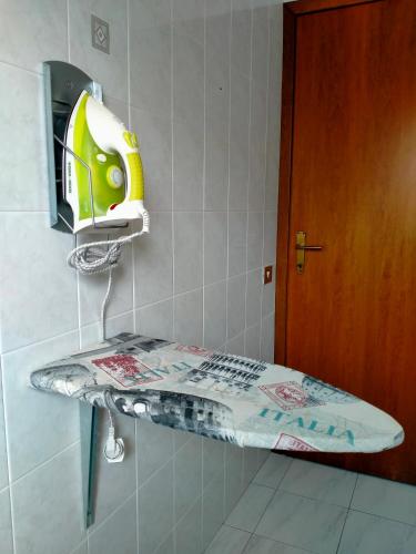 a shelf in a bathroom with a helmet on the wall at Apartment in Sardinia in Decimomannu