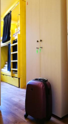 a purple suitcase sitting in a room with a bedroom at Булгакоff- укриття поряд, 20 метрів in Kyiv