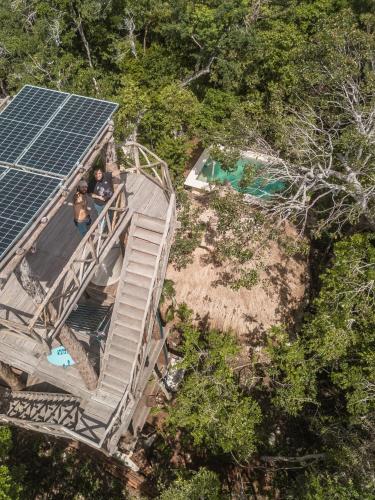 two people sitting on the stairs of a house with a solar panel at Blue Monkey Chemuyil in Chemuyil