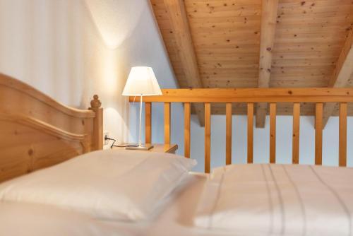 a bedroom with a crib and a table with a lamp at Peintenhof Typ B in Sand in Taufers
