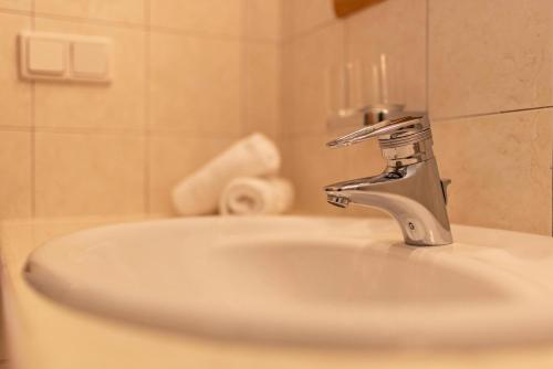 a bathroom sink with a silver faucet at Peintenhof Typ B in Sand in Taufers