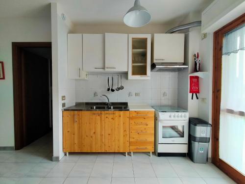 a kitchen with a sink and a stove at Apartment in Sardinia in Decimomannu