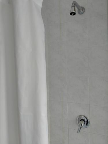 a shower with a shower head in a bathroom at Apartment in Sardinia in Decimomannu