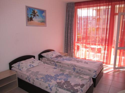 a small room with two beds and a window at Apartments and studios in Cote d’Azure in Sunny Beach