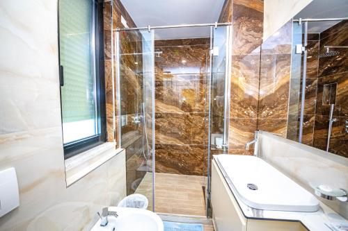 a bathroom with a shower and a sink at Hotel Bella Vista in Durrës