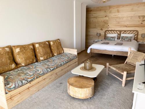a living room with a couch and a bed at Sesimbra Natural Room and private access in Sesimbra