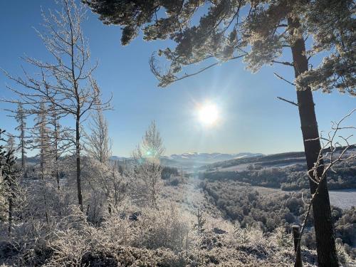 a winter view of a valley with snow covered trees at West Gorton in Grantown on Spey