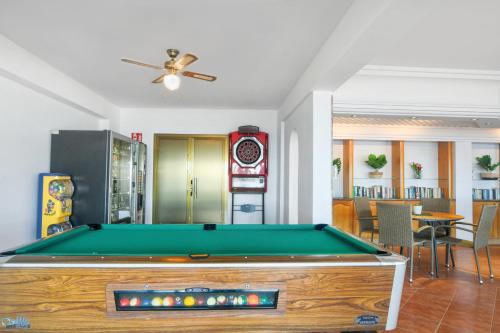 a pool table in a living room with a ceiling fan at Apartamentos Mirador in Benidorm