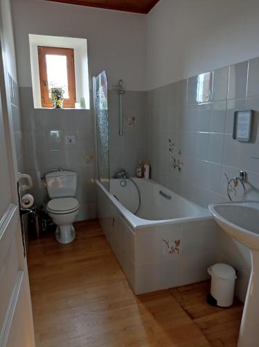 uma casa de banho com uma banheira, um WC e um lavatório. em MAISON DE FAMILLE em Cénac-et-Saint-Julien