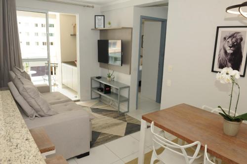 a living room with a couch and a table at ACONCHEGO E BEM ESTAR in Brasilia