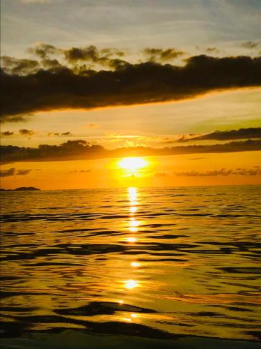 a sunset over the ocean with the sun setting at A Spelunca in Speloncato
