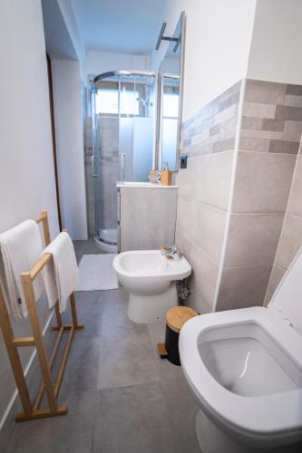 a bathroom with a toilet and a sink and a shower at WiBnB Holiday rentals- appartamenti in Turin