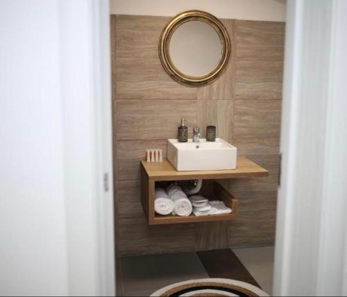 a bathroom with a sink and a mirror and towels at Valea Putnei Residence- Rooms for rent in Valea Putnei