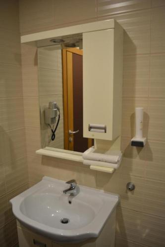 a bathroom with a sink and a mirror at Hotel Lukavac in Lukavac