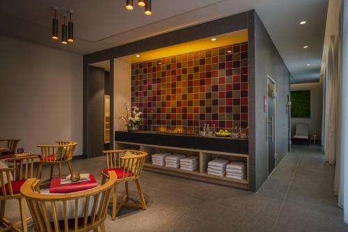 a restaurant with chairs and a counter with towels at IntercityHotel Zürich Airport in Rümlang