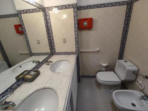 a bathroom with a sink and a toilet at 51 VilaMar - Casas & Papeis in Porches