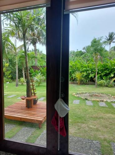 a window with a view of a park with a bench at Happy's Homestay in Boracay