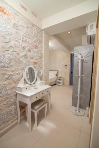 a bathroom with a sink and a mirror on a wall at Evgeniko Villa in Kardamyli