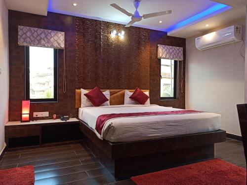 a bedroom with a large bed and a window at Hotel A P Home's - A Boutique Hotel in Guwahati