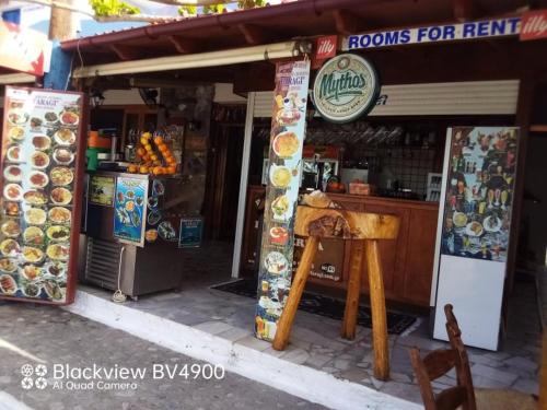 a food stand with a sign on the front of it at Faragi in Agia Roumeli