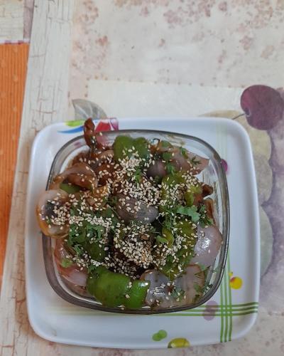 a glass bowl filled with mushrooms and vegetables on a table at Sukoon.Homestay in Rājpur