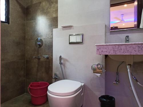 a bathroom with a toilet and a sink at Hotel A P Home's - A Boutique Hotel in Guwahati