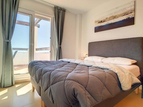 a bedroom with a bed and a large window at Las Terrazas de La Torre Golf - 6709 in Roldán