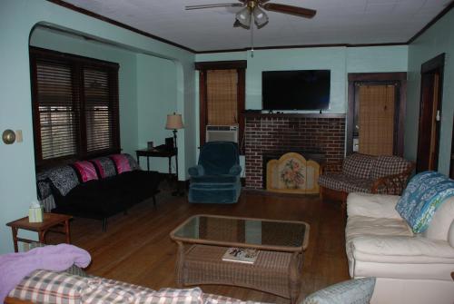 a living room filled with furniture and a flat screen tv at Old Time Beach Front Cottage - The Beach is your Backyard! Pet Friendly cottage in North Camellia Acres