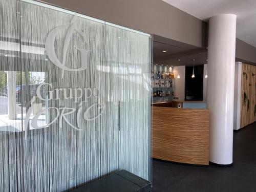 a restaurant with a sign on a glass wall at Hotel Europa Belluno in Belluno