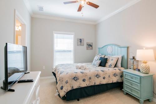 - une chambre avec un lit et un bureau avec une télévision dans l'établissement Lost Key 14383 Cordgrass Ln By Pkrm, à Pensacola