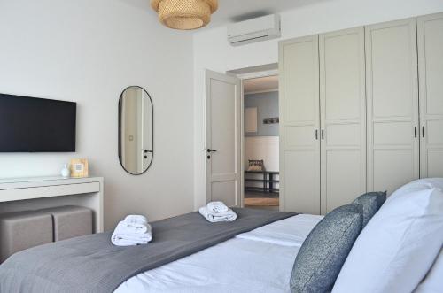 a bedroom with a bed with towels on it at Apartment Céleste - Directly on the Beach in Mošćenička Draga