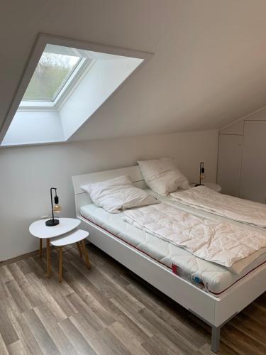 a bedroom with a bed and a table at Ferienwohnung Lara in Ludwigswinkel