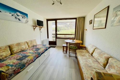 a living room with a couch and a table at Nice 28m Comfort In The Heart La Salle Les Alpes in La Salle Les Alpes