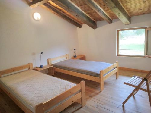 1 dormitorio con 2 camas y ventana en LE PETIT FROUAS CENTRE en Vielle-Saint-Girons