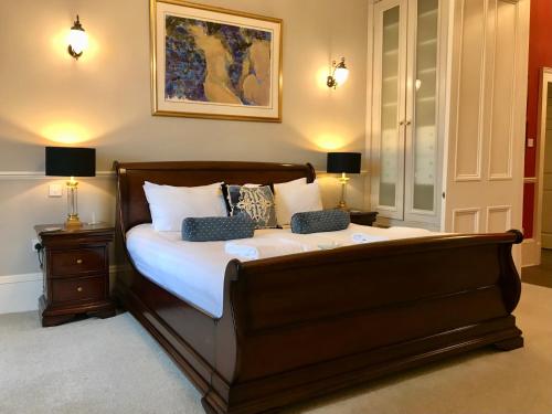 a bedroom with a bed with two night stands and two lamps at Escape To Edinburgh @ Albyn Place in Edinburgh