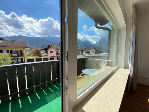 a balcony with a view of the mountains at Ferienhaus Butterfly 2 in Garmisch-Partenkirchen