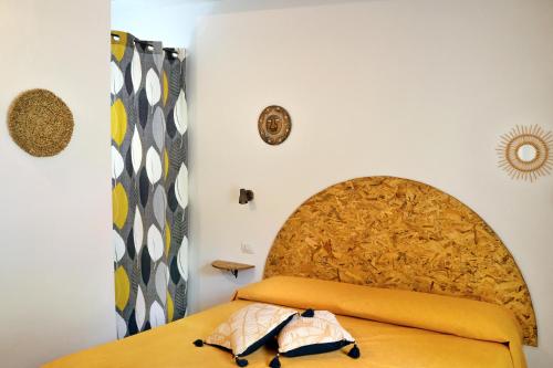 a bedroom with a bed with a large wooden headboard at Amaranto in Maratea