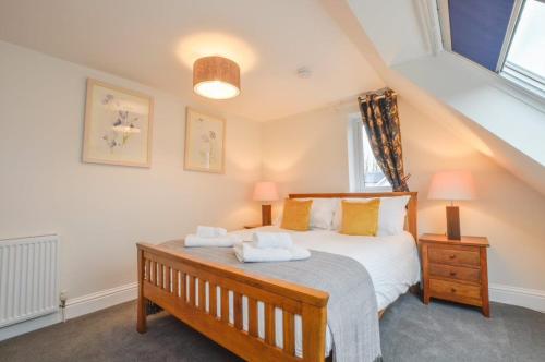 a bedroom with a bed with two towels on it at Blackmount House in Oban