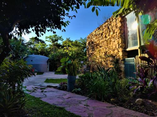 a stone walkway in front of a house at Pousada Zazen in Vale do Capao