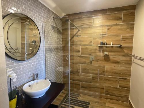 a bathroom with a sink and a shower at Oubaai Golf Estate in George